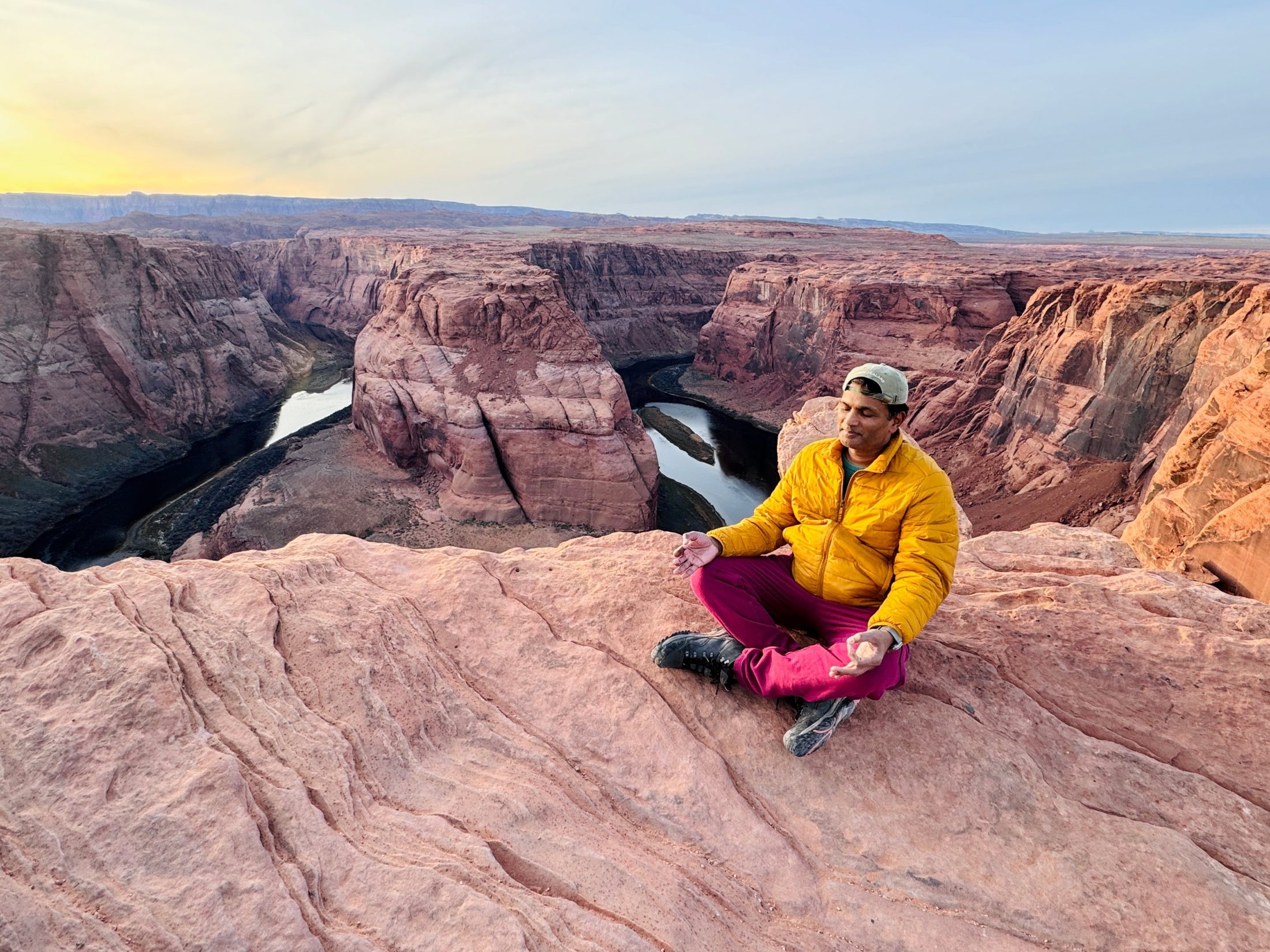 Jay meditating on the rim of Horseshoe Bend at dawn