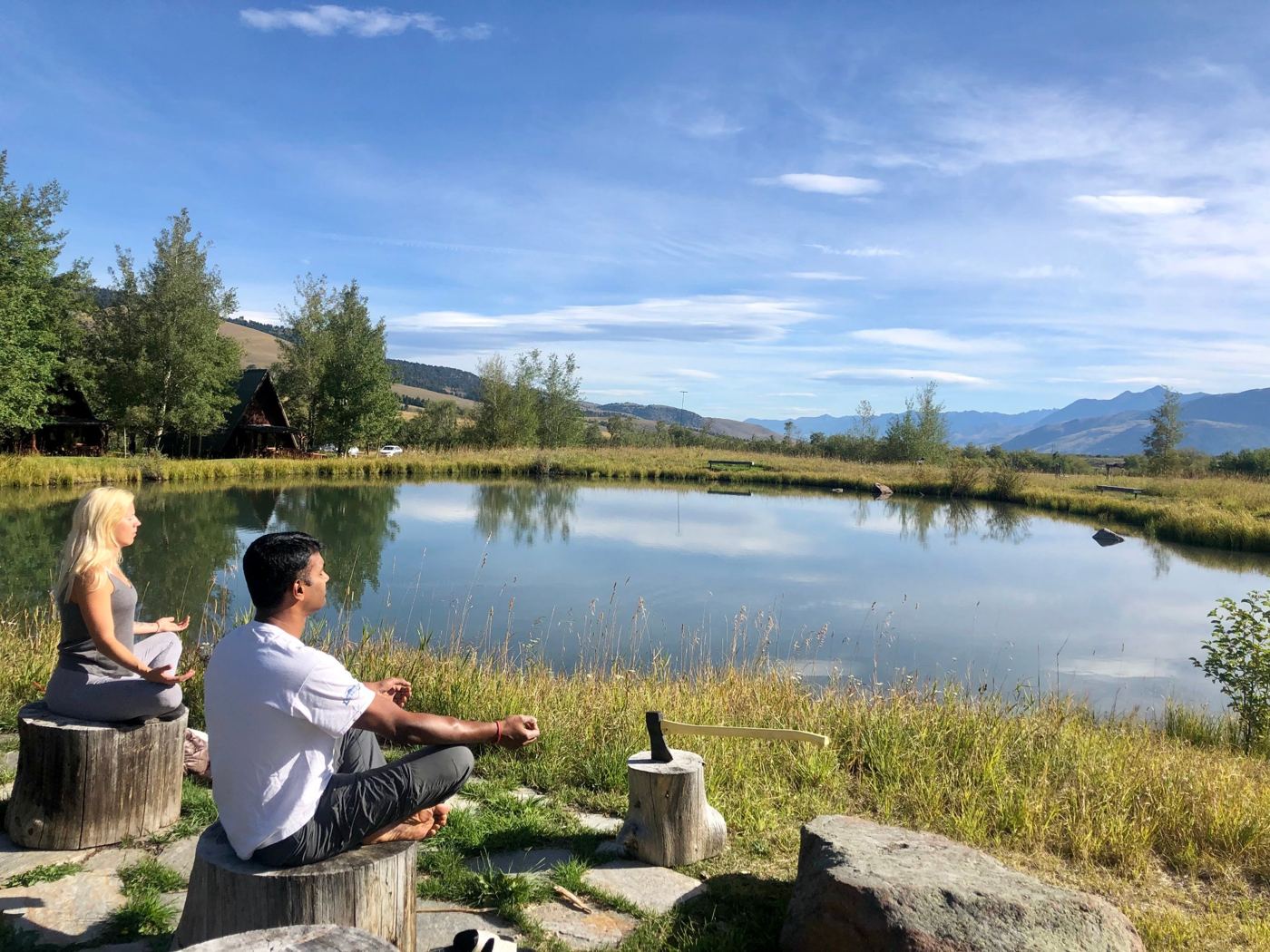 Jay meditating beside a pond in Montana